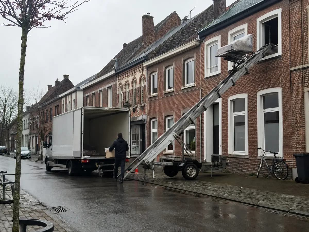 Verhuisfirma Arendonk: verhuiswagen op de oprit en ladderlift aan een woning in Arendonk